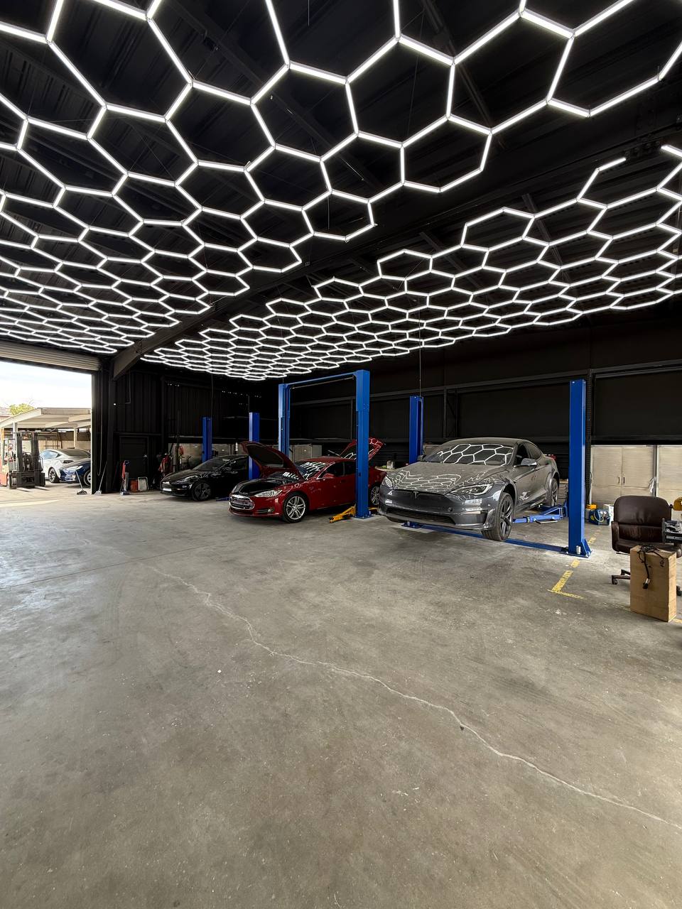 Tesla vehicles and service lifts inside TSL Service